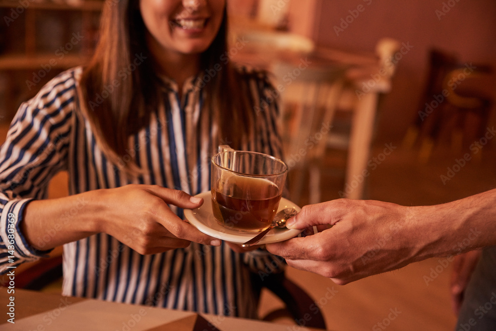 Millenial accepting a half cup of tea Millenial accepting a half cup of tea