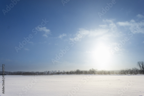 beautiful winter rural landscape with river, trees, field and snow