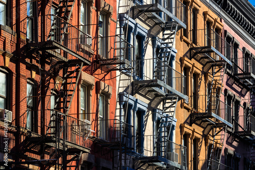 Colorful Soho building facades with painted fire escapes. Manhattan, New York City photo