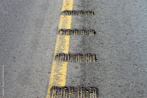 Closeup view of rumble strips on a road