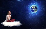 Woman sitting on cloud looking at planet earth