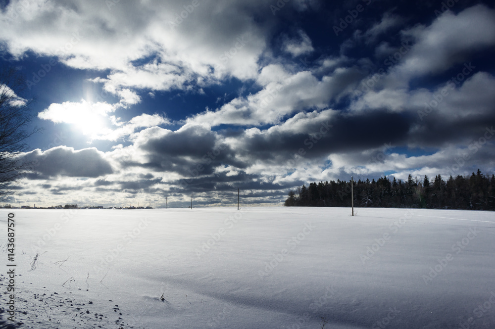 Winter landscape with snow covered countryside. European winter landscape. Blue sky, bright sun and white snow.