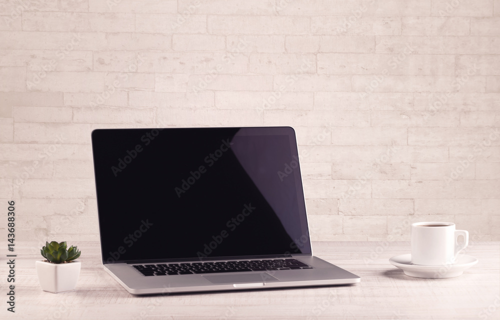 Office desk closeup with white brick wall Office desk closeup with white brick wall