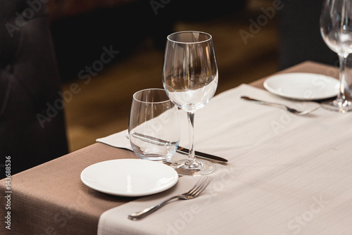View of the served table in a restaurant. beige brown tones