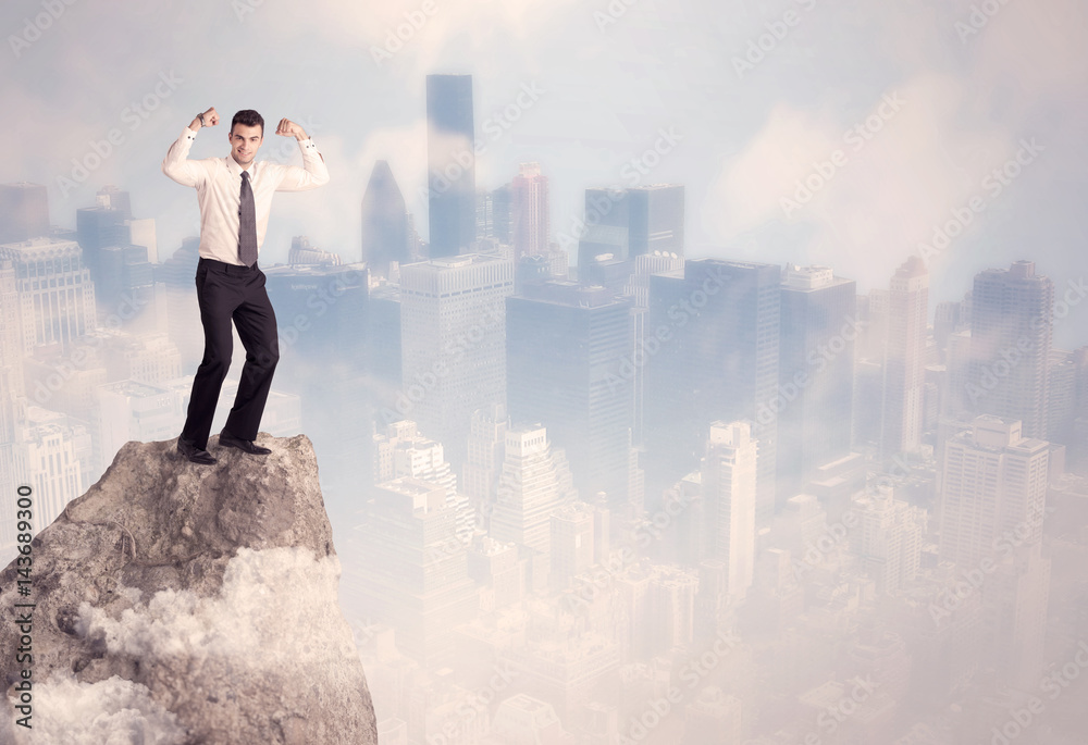 Winner urban businessman on top of stone Winner urban businessman on top of stone
