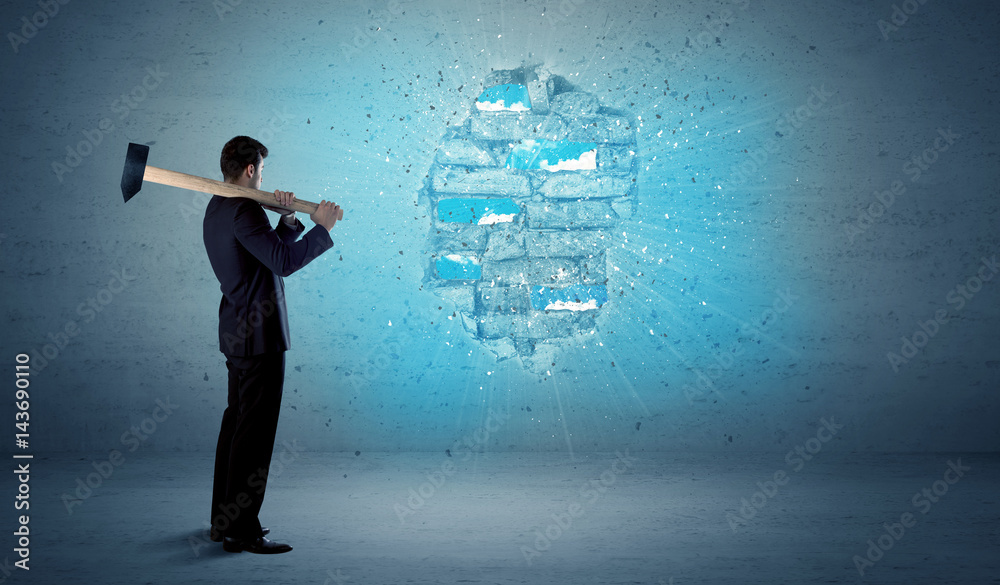 Business man hitting brick wall with huge hammer Business man hitting brick wall with huge hammer