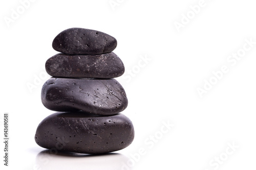 Black stones stacked one above the other isolated on white background