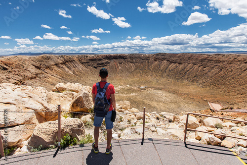 Travel in Meteor Crater, man hiker with backpack enjoying view, Winslow, Arizona, USA photo