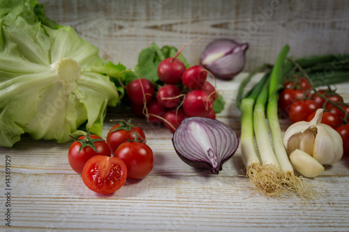 Fresh seasonal vegetables on the white wooden background