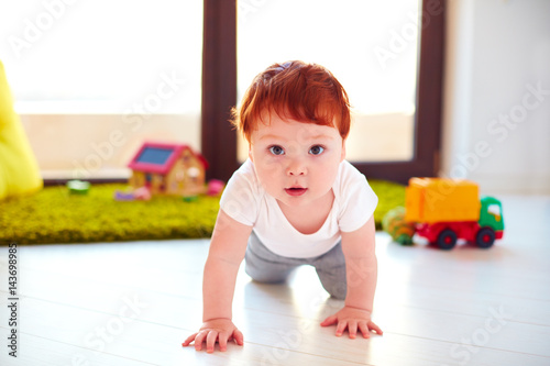 cute toddler baby crawling on the floor at home