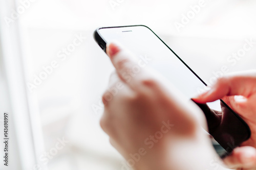 Woman using mobile smartphone. Modern or business concept. Close-up corporate smartphone approach.