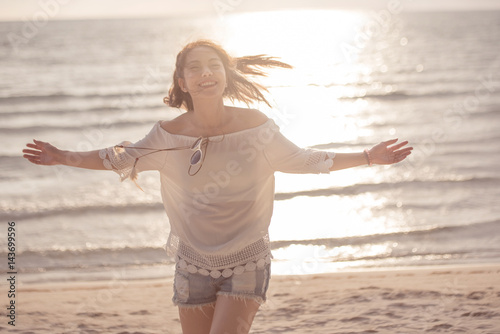 Photography Freedom woman in free happiness bliss on beach, female model Smiling in summer enjoying serene ocean nature during travel holidays vacation outdoors