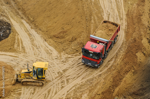 bulldozer and truck at the site