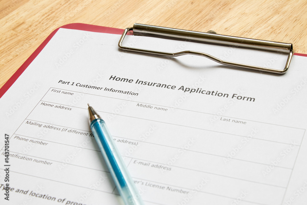 Home insurance application form with red file on wooden table