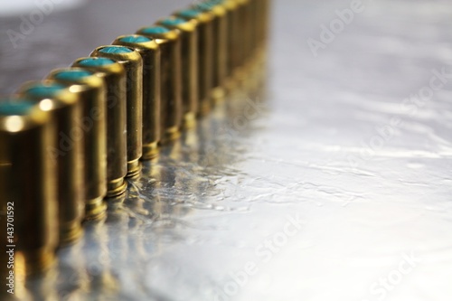 Metal gun hubs munitions on shiny silver desk