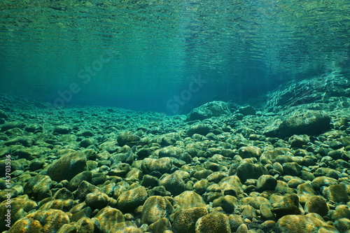 River underwater,  pebbles on the riverbed with clear water, natural scene, Dumbea, New Caledonia, south Pacific photo