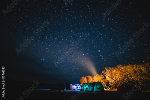 Tent parking with cars under the starry sky