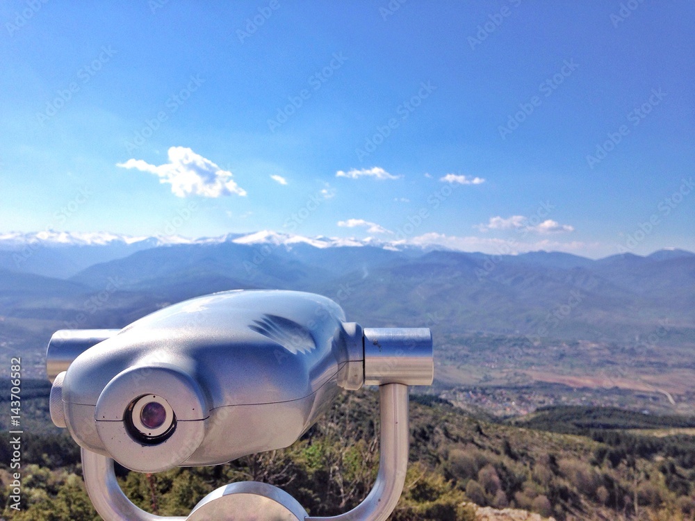 Tourist pay binocular overview a mountain