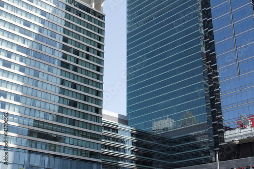 Cityscape view with business buildings with contemporary architecture in metropolitan city in day. High-rise modern skyscrapers in big town against grey sky