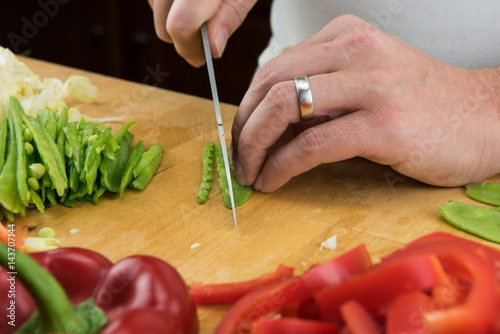 Close Up of Snow Peas Being Sliced