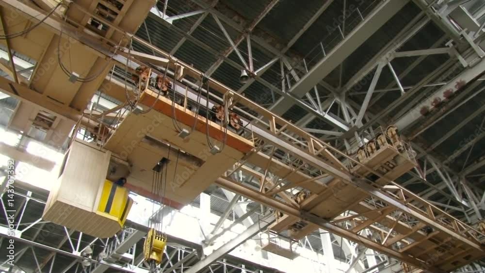 Factory Building Inside. Steel Platform Frame Hanging up High. Metal Cunstruction of Airshed. Ground View Factory Building Inside. Steel Platform Frame Hanging up High. Metal Cunstruction of Airshed. Ground View