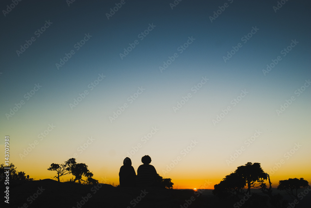 Two girls silhouettes at sunrise in Brazil