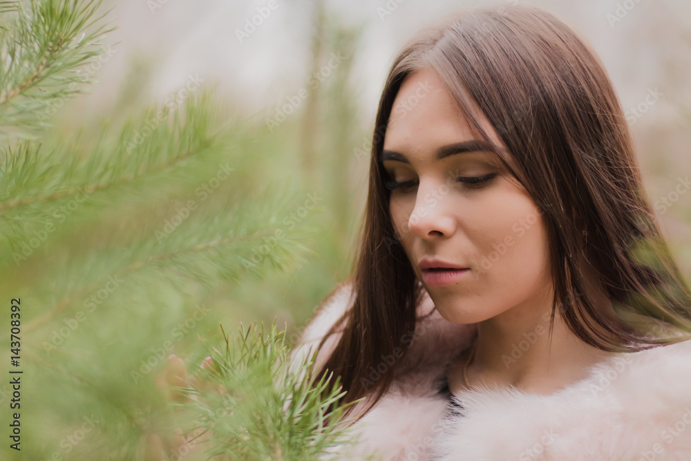 Portrait of a very beautiful girl in a forest dressed in fur Portrait of a very beautiful girl in a forest dressed in fur