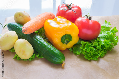 fresh vegetables. Tomatoes, potatoes, cucumber, peppers, onions, lettuce, carrots, cabbage on a table.