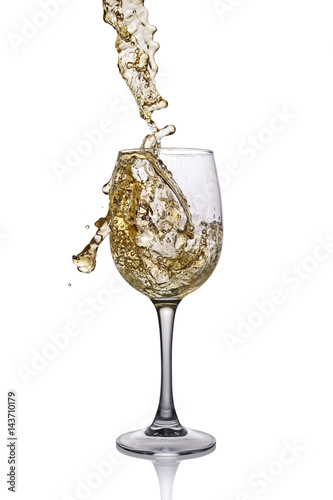 Splash of white wine in glass with reflection