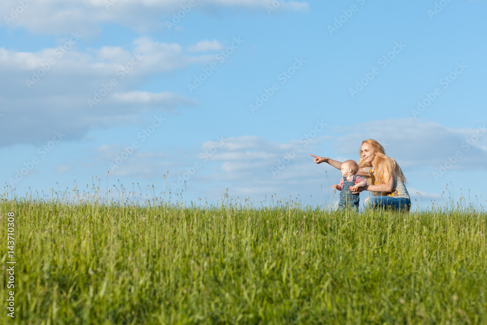 Mom and daughter on a walk. Mom points hand forward Mom and daughter on a walk. Mom points hand forward