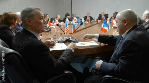 Relations between United States and Russian Federation. Ambassadors from different countries shake hands and talk about partnership.