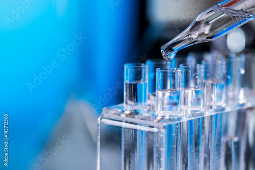 Science laboratory research and development concept. microscope with test tubes photo