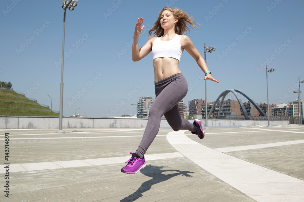 Run woman exercising with urban background
