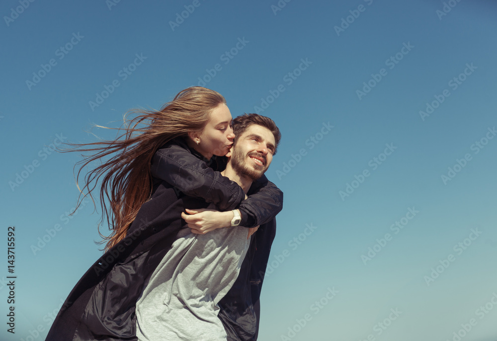 young beautiful loving couple in hipster fashion style posing on a Sunny beach. Happy smiling and laughing. outdoor portrait. Relationship betweem man and woman