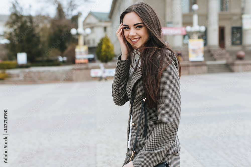 Business woman walking on a street.