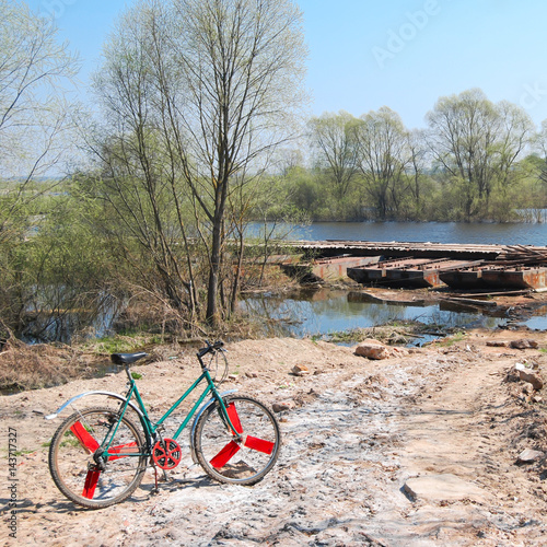 Old bicycle on off road terrain near the river
