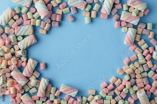 Colorful mini marshmallows background frame. Copy space for text.