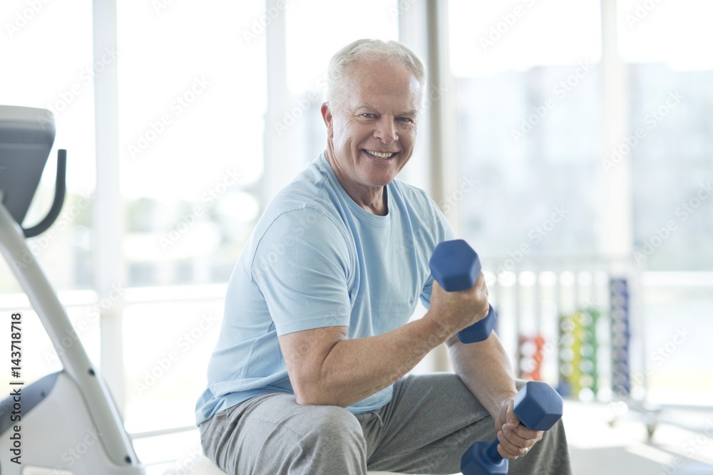 Senior man using weights Senior man using weights