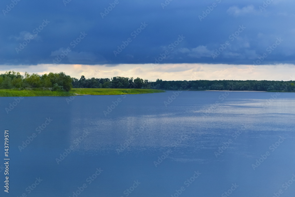 Blue storm clouds over the river. Background, plenty of space for text. Blue storm clouds over the river. Background, plenty of space for text.