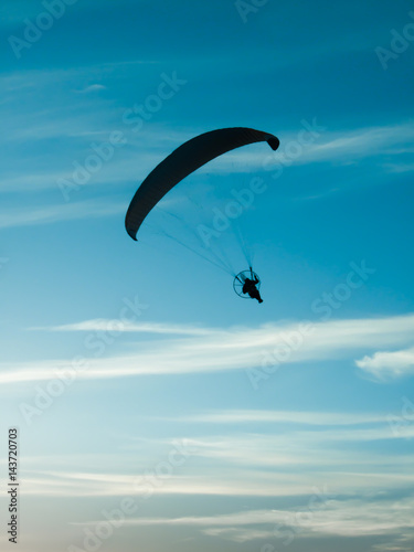 Paragliding in the cloudy sky