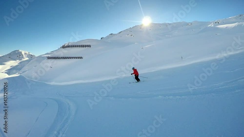 Man skiing on the prepared slope with fresh new powder snow in Tyrolian Alps, Zillertal, Austria  photo