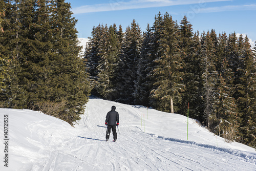 Skier on a piste in alpine ski resort