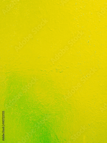 Yellow green metal texture with a roughness and drops of paint surface. Grunge urban background.