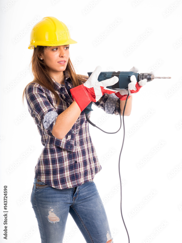 Bellissima ragazza operaia con il trapano in mano e casco antifortunistico Bellissima ragazza operaia con il trapano in mano e casco antifortunistico