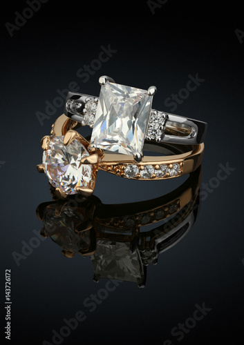 Two jewelry rings with big diamonds on black background
