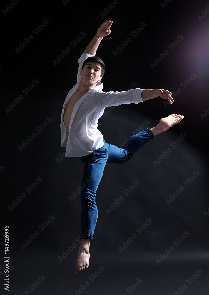 Handsome young ballet dancer on dark background Handsome young ballet dancer on dark background