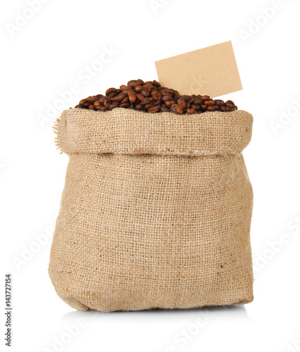 Bag with roasted coffee beans on white background