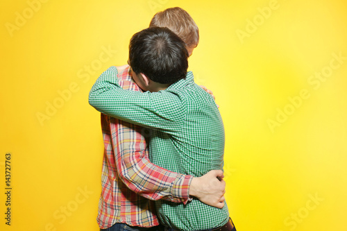 Happy gay couple posing on ...