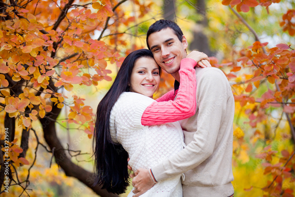 photo of cute couple hugging on the wonderful yellow trees background photo of cute couple hugging on the wonderful yellow trees background