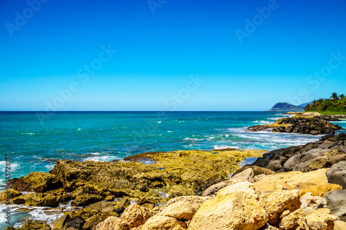 The rocky shoreline of the west coats of the island of Oahu at the resort area of Ko Olina in the island state of Hawaii in the Pacific Ocean